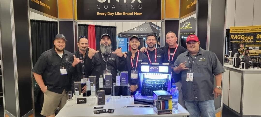 A group of men are posing for a picture in front of a table.