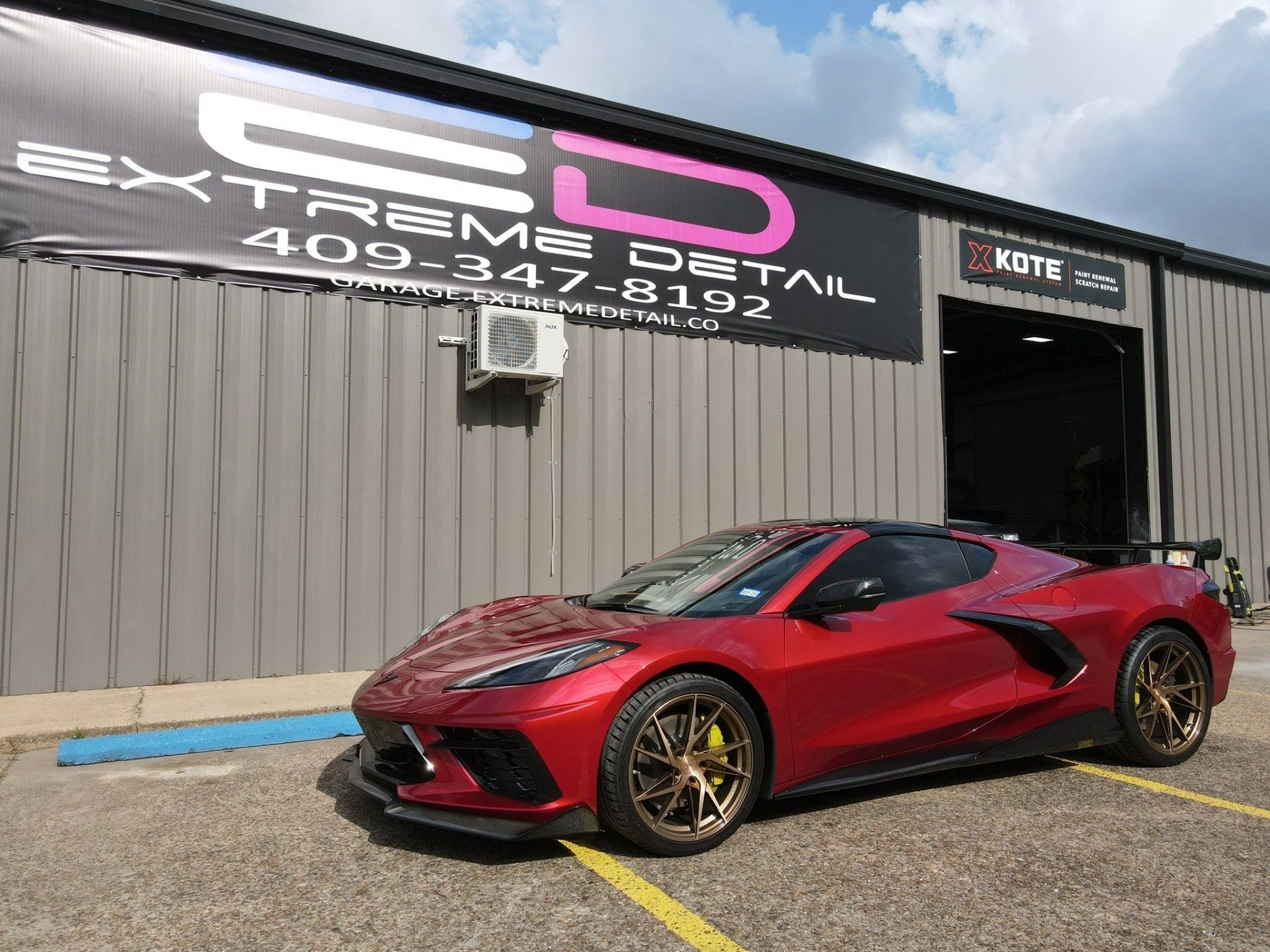 A red sports car is parked in front of a building.