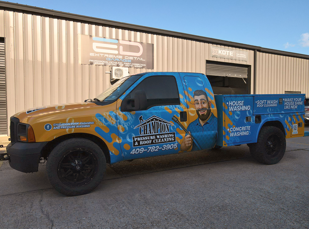 A blue and yellow truck is parked in front of a building.
