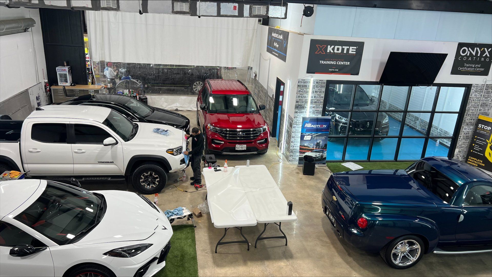 A group of cars are parked in a showroom.