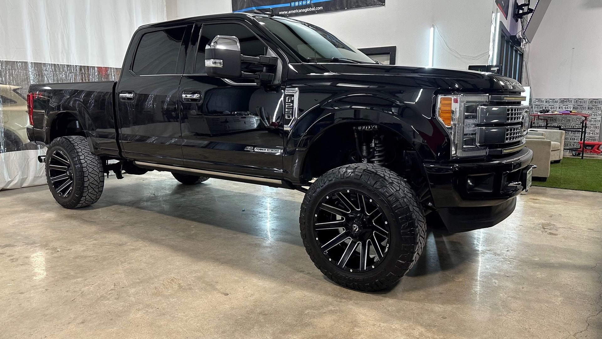 A black pickup truck is parked in a garage.