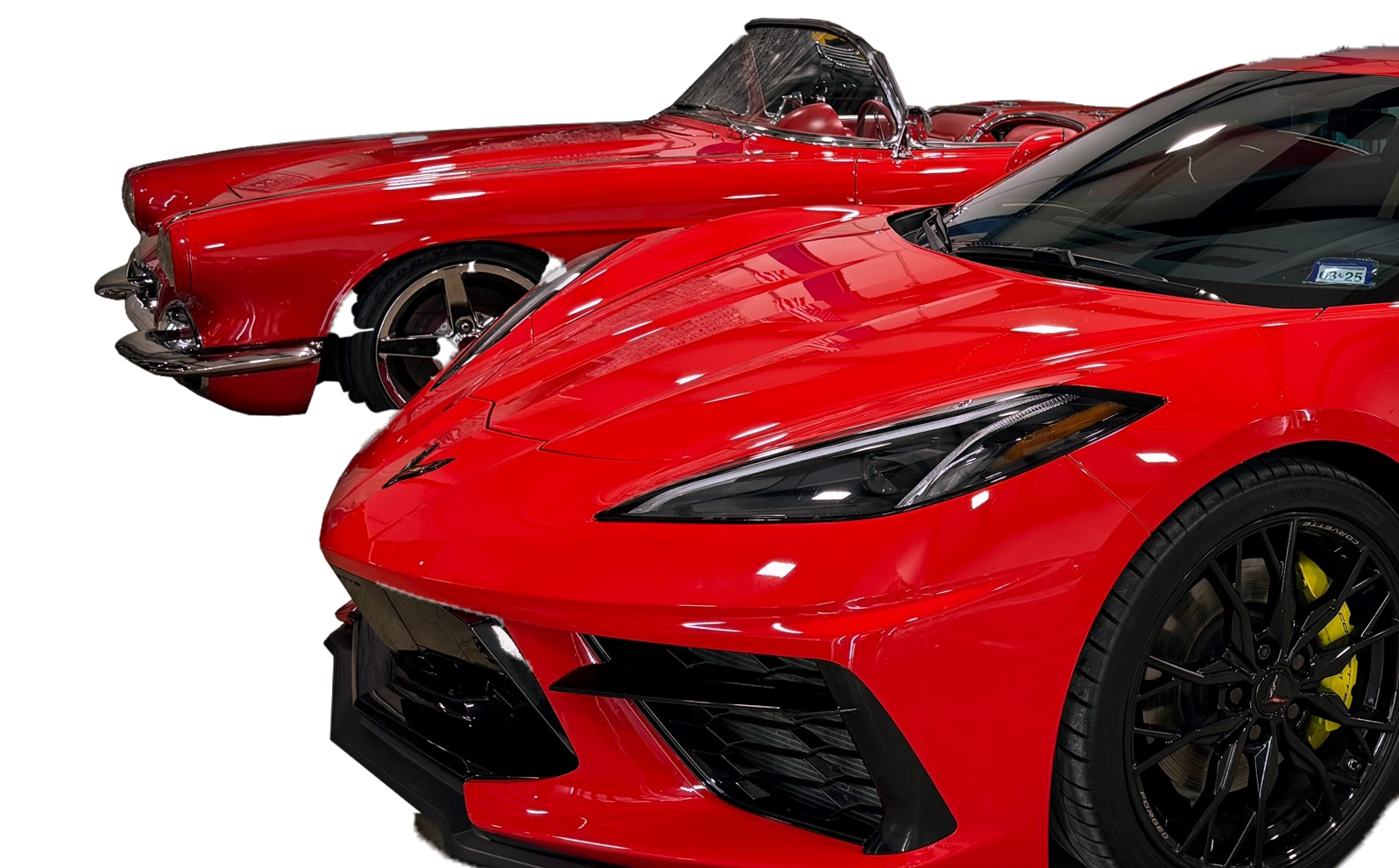 Two red sports cars are parked next to each other on a white background.