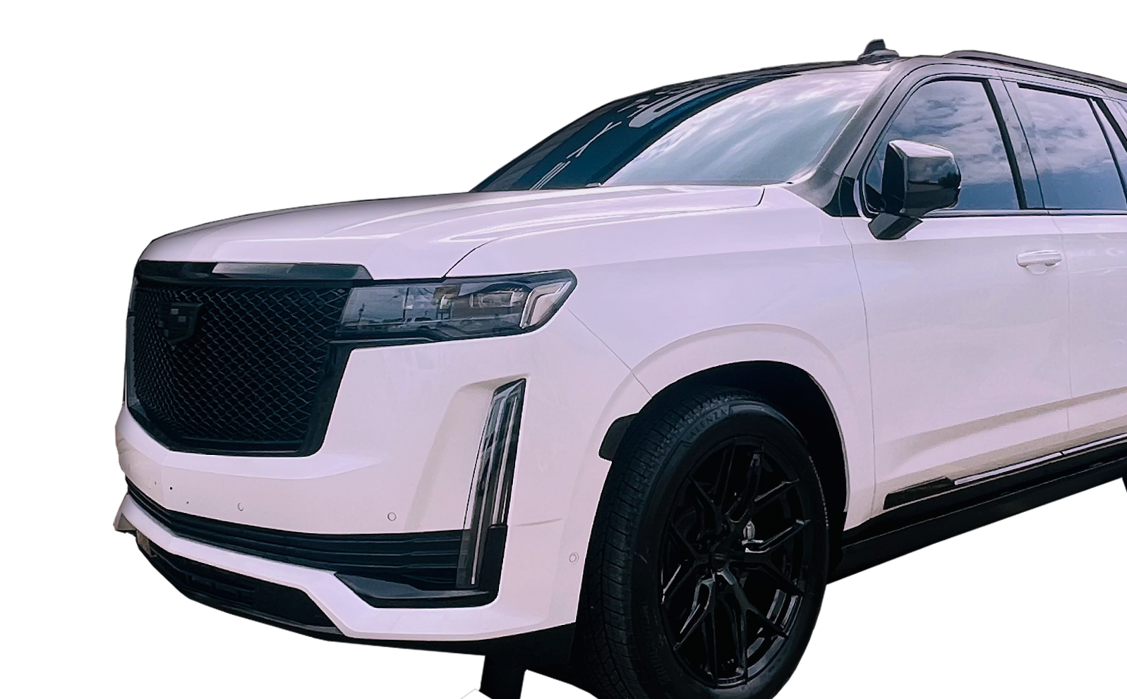 A white car with black wheels is parked on a white background.
