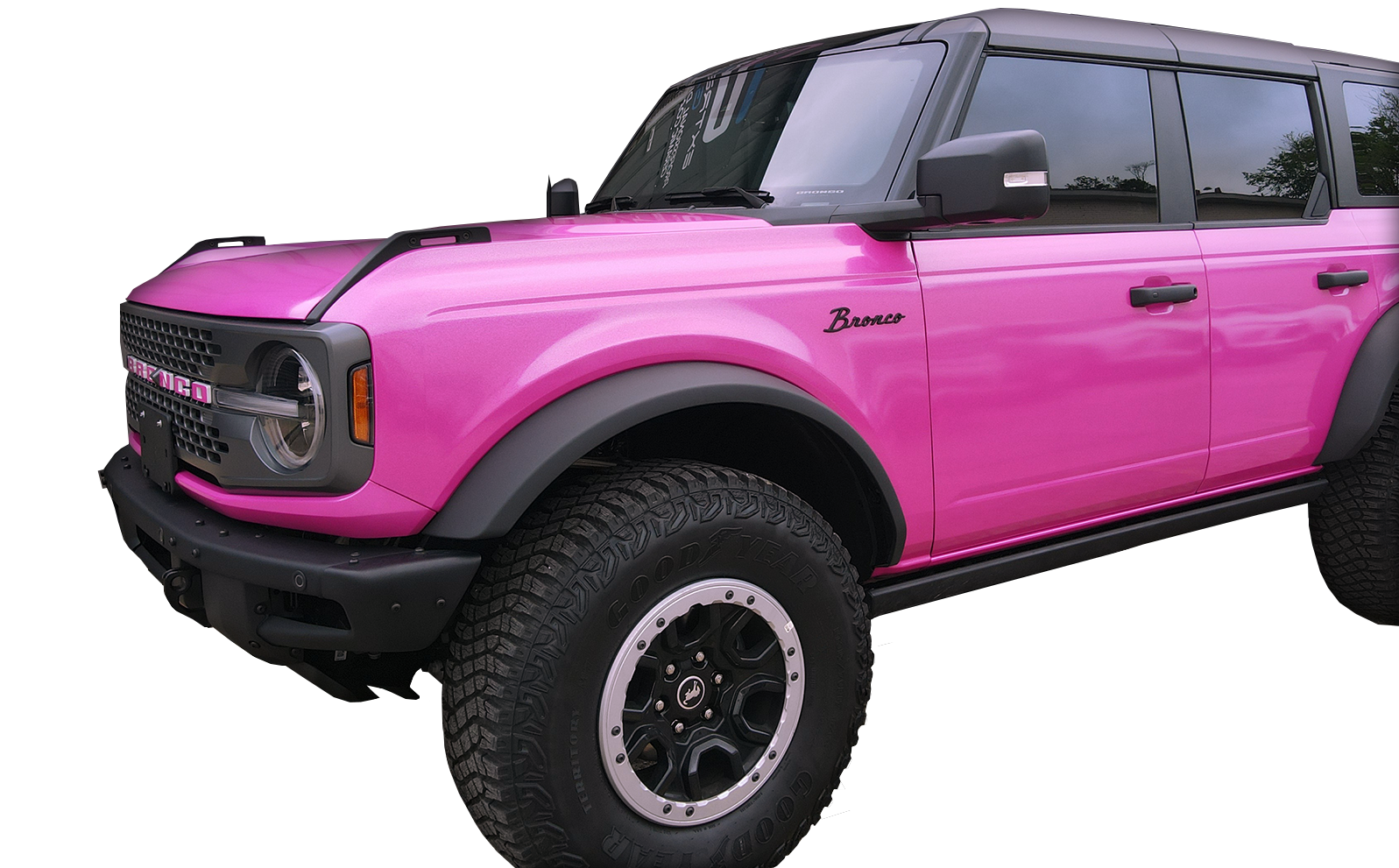 A pink ford bronco is parked on a white background.