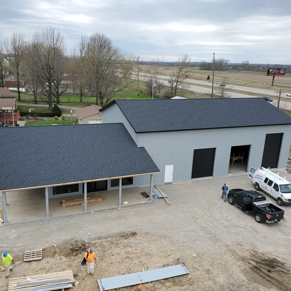 An aerial view of a building with a black roof