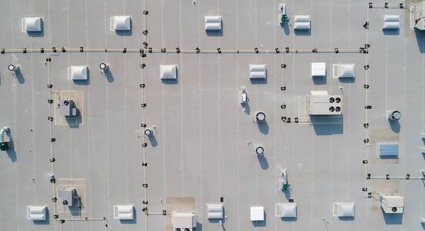 An aerial view of the roof of a building with a lot of vents.