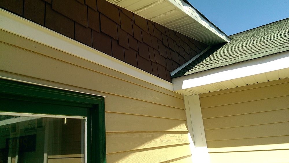 A house with a green window and a brown roof