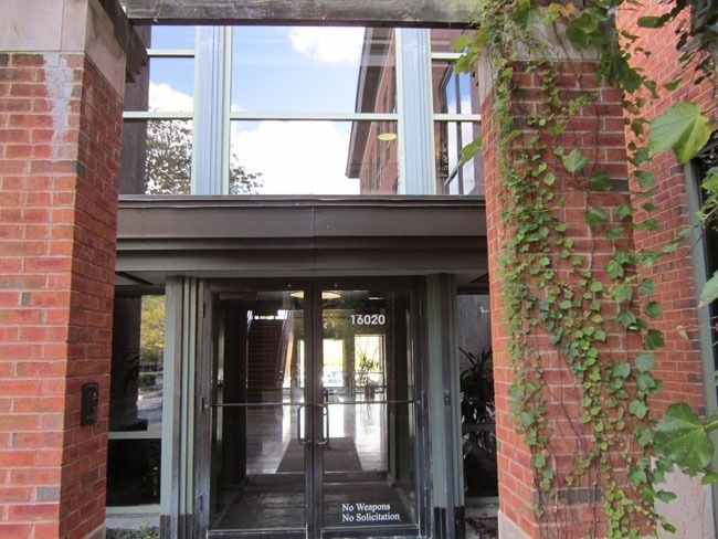A brick building with a glass door and a sign that says ' for tenants only ' on it