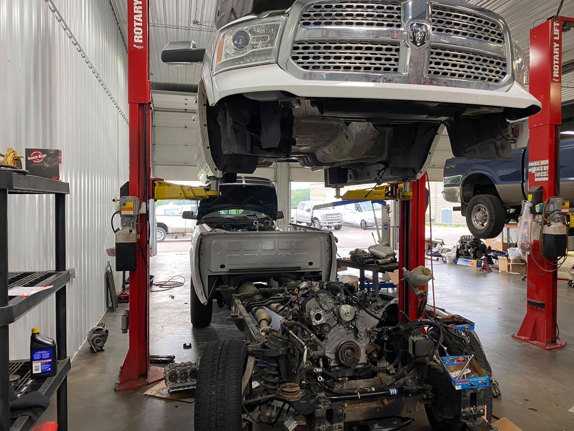 A dodge ram truck is being worked on in a garage.