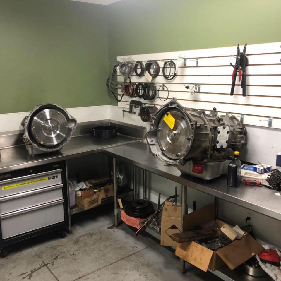 A room with a stainless steel counter top and a machine on it
