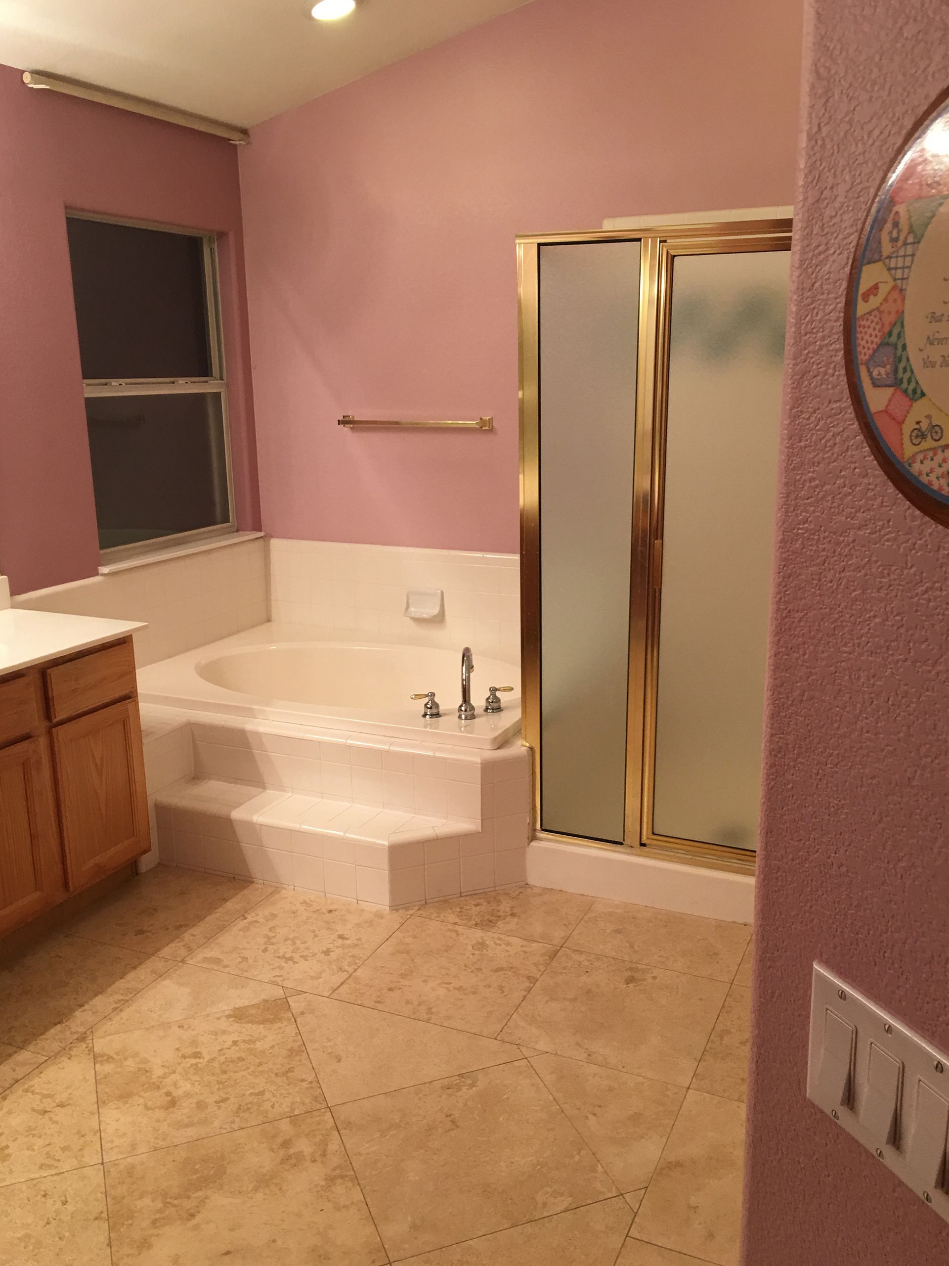 A bathroom with a tub and a walk in shower