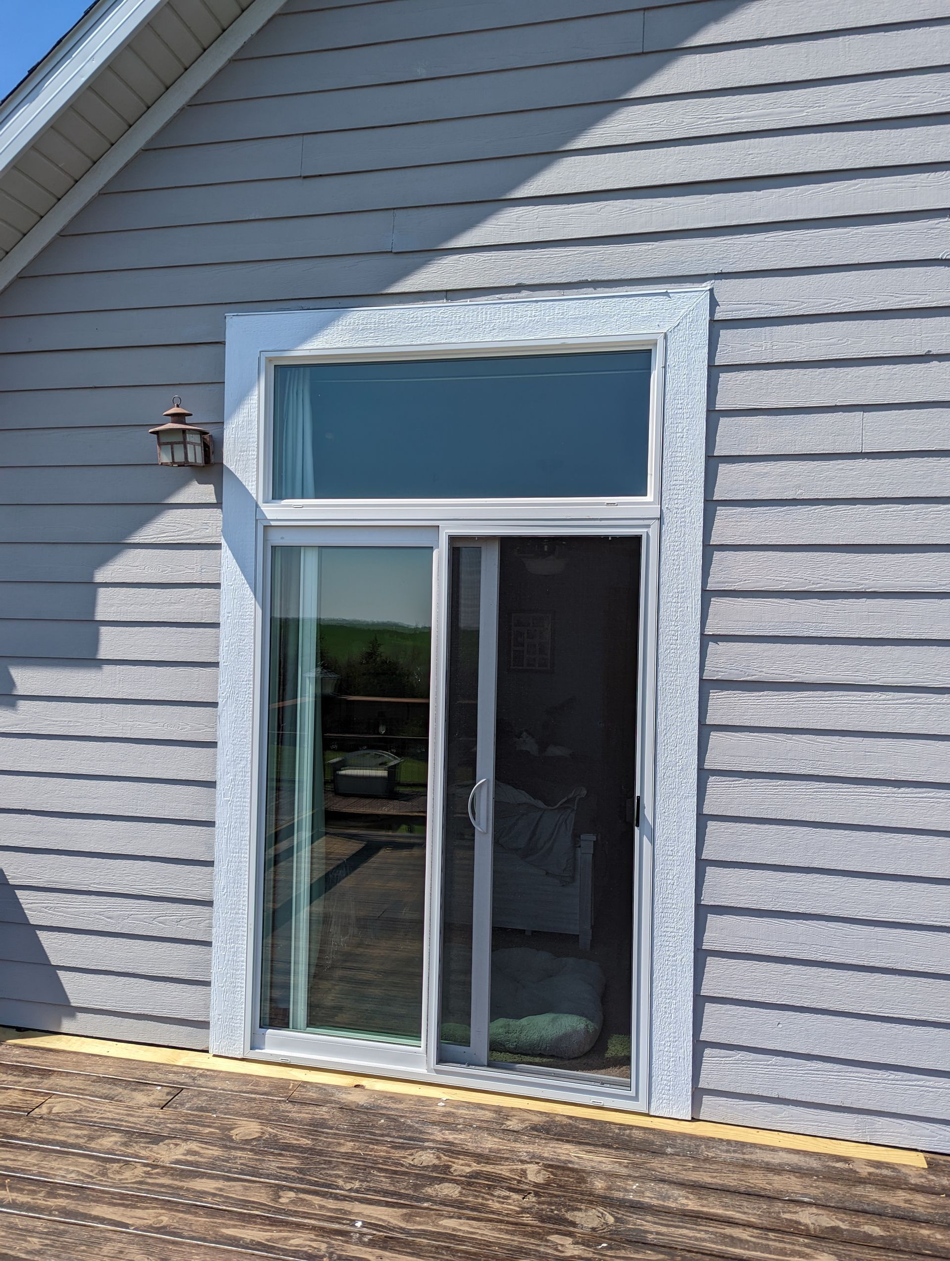 A sliding glass door is on the side of a house