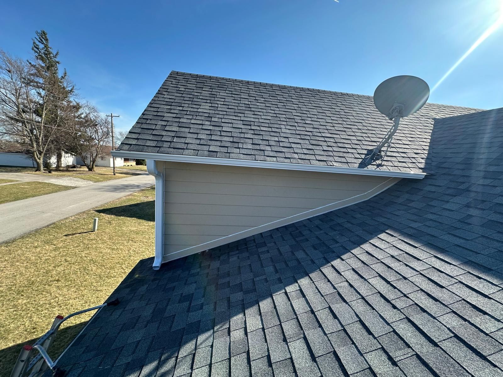 The roof of a house with a satellite dish on it