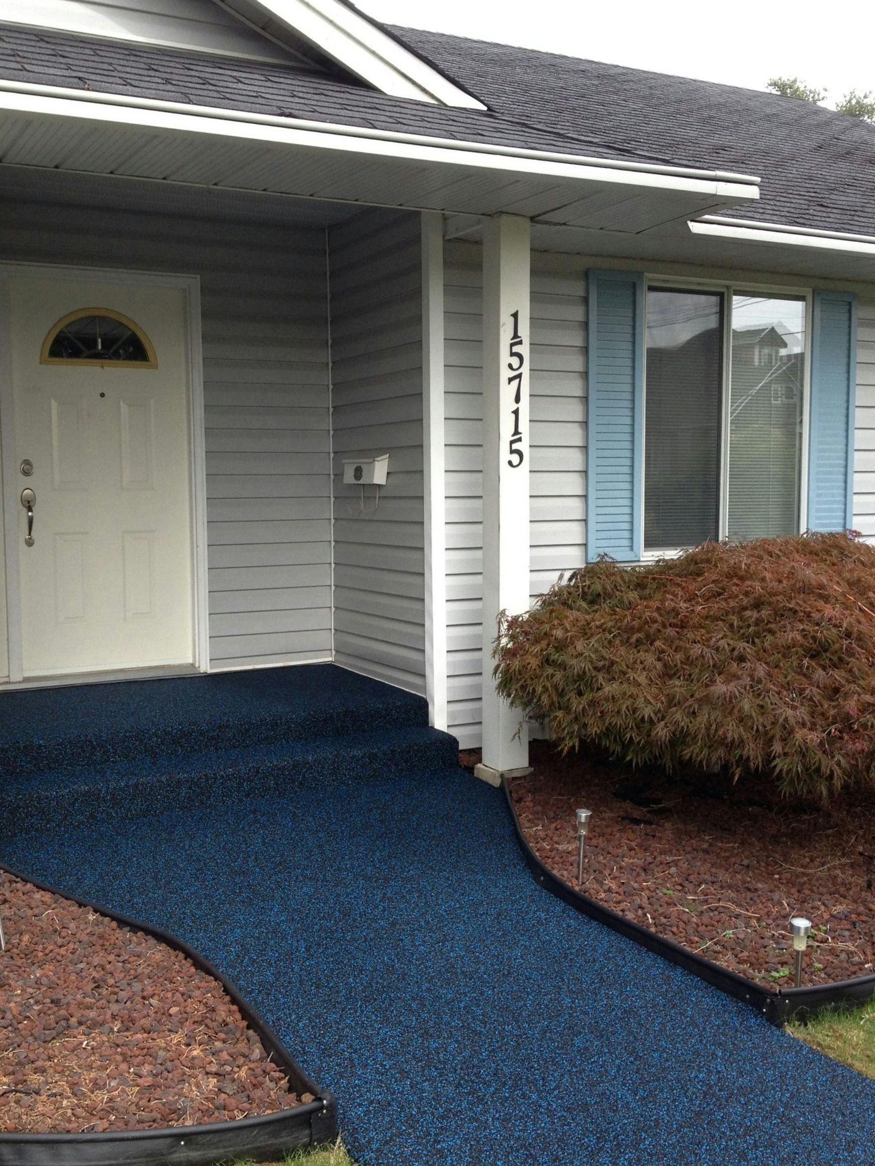 A house with a blue walkway leading to the front door