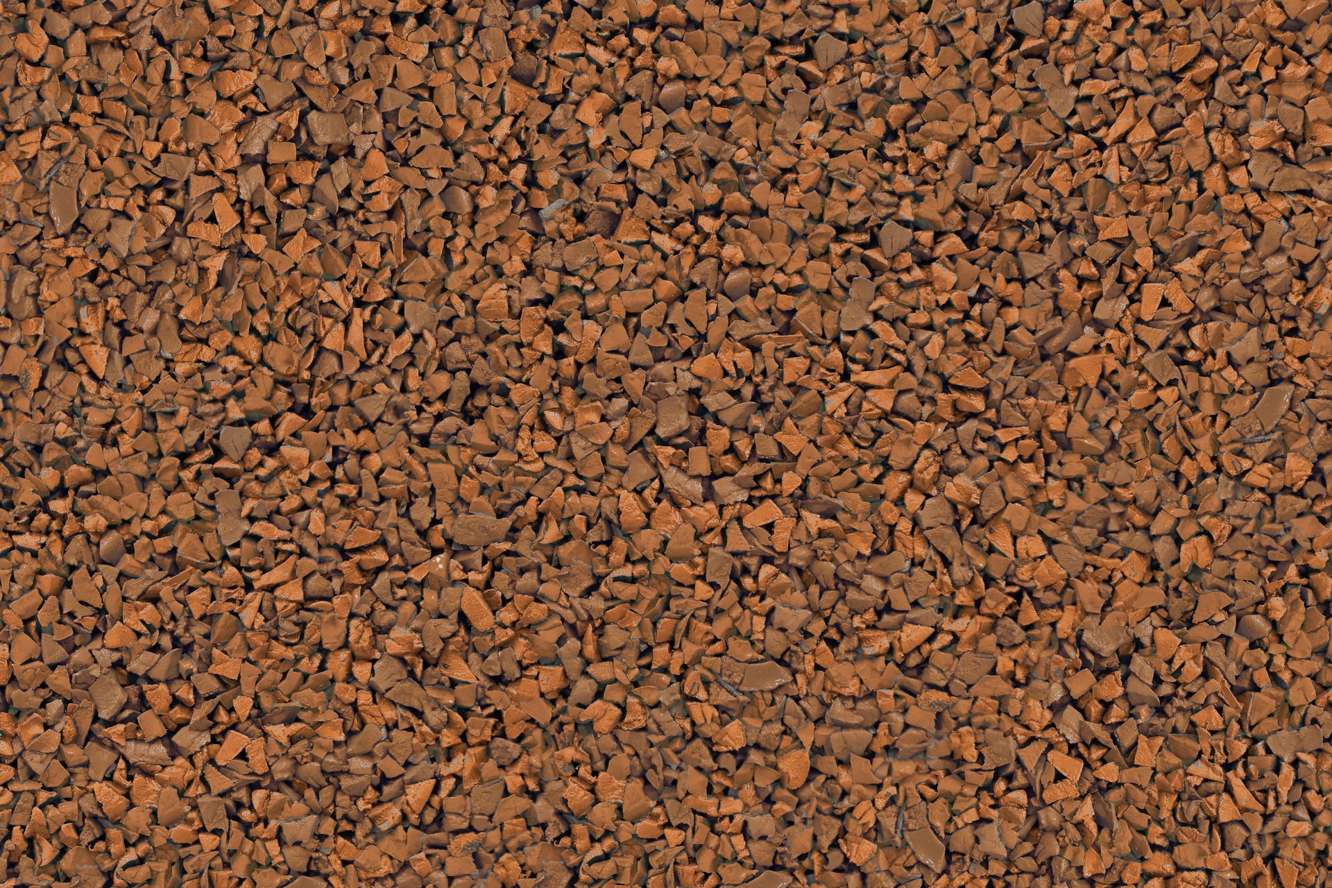 A close up of a pile of brown gravel.