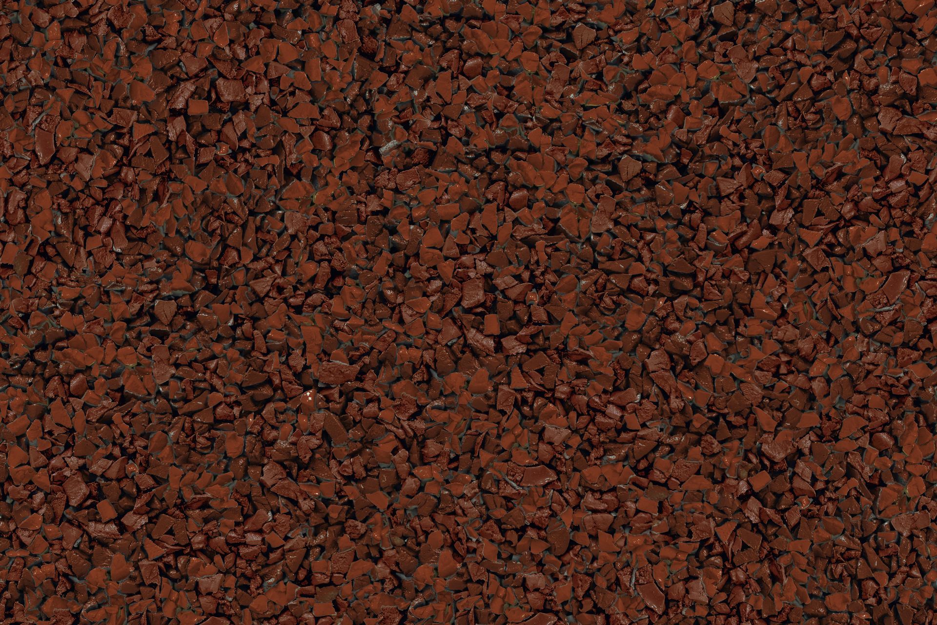 A close up of a pile of red gravel.