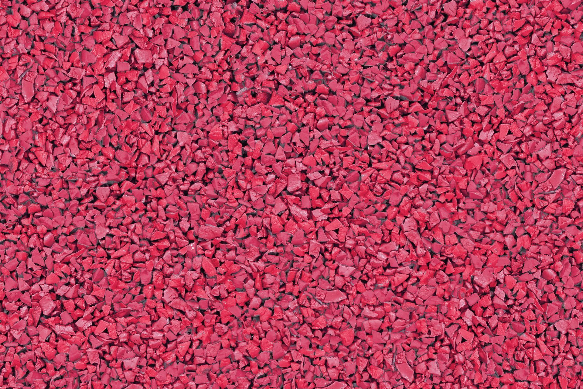 A close up of a pile of red gravel.
