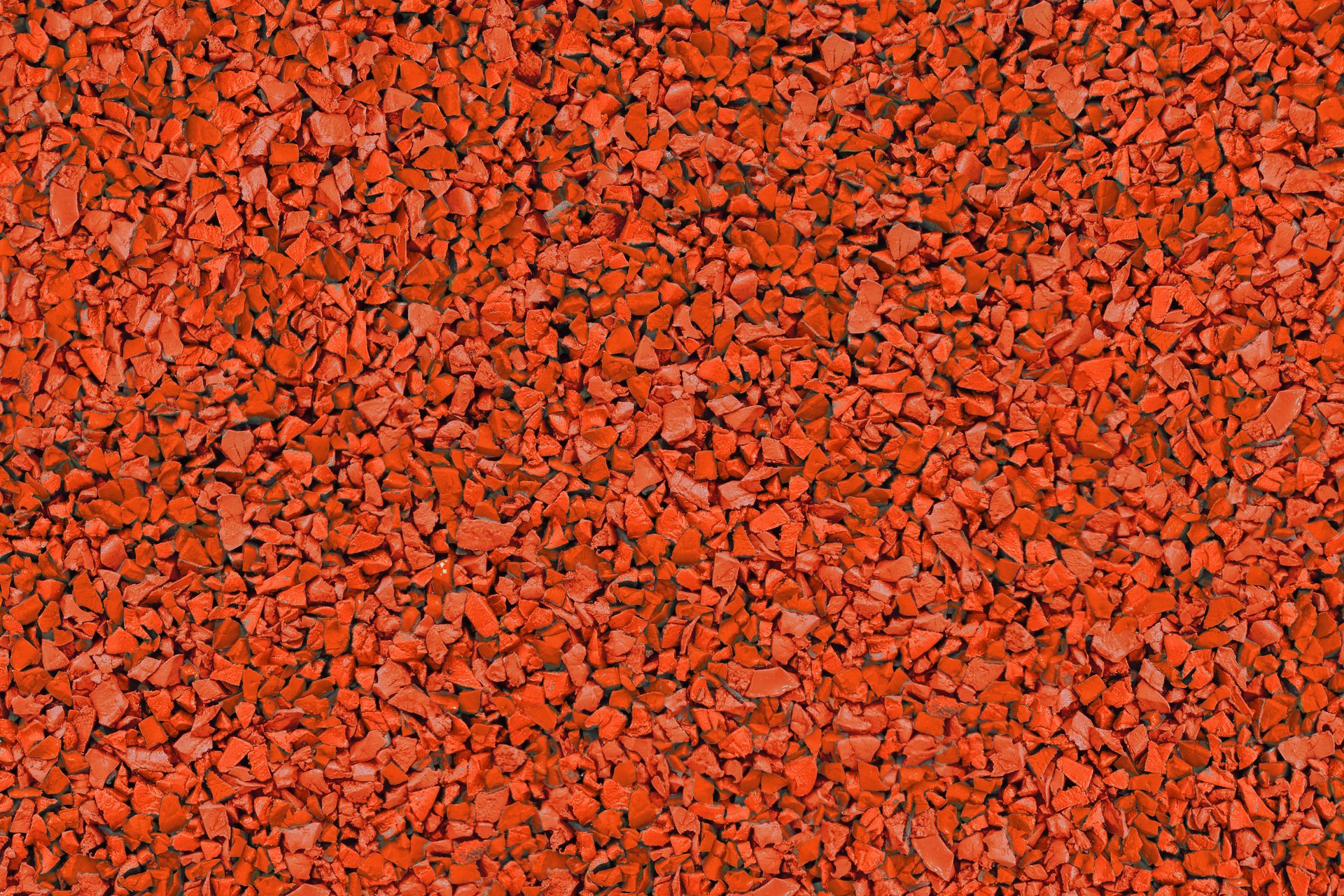 A close up of a pile of red gravel.