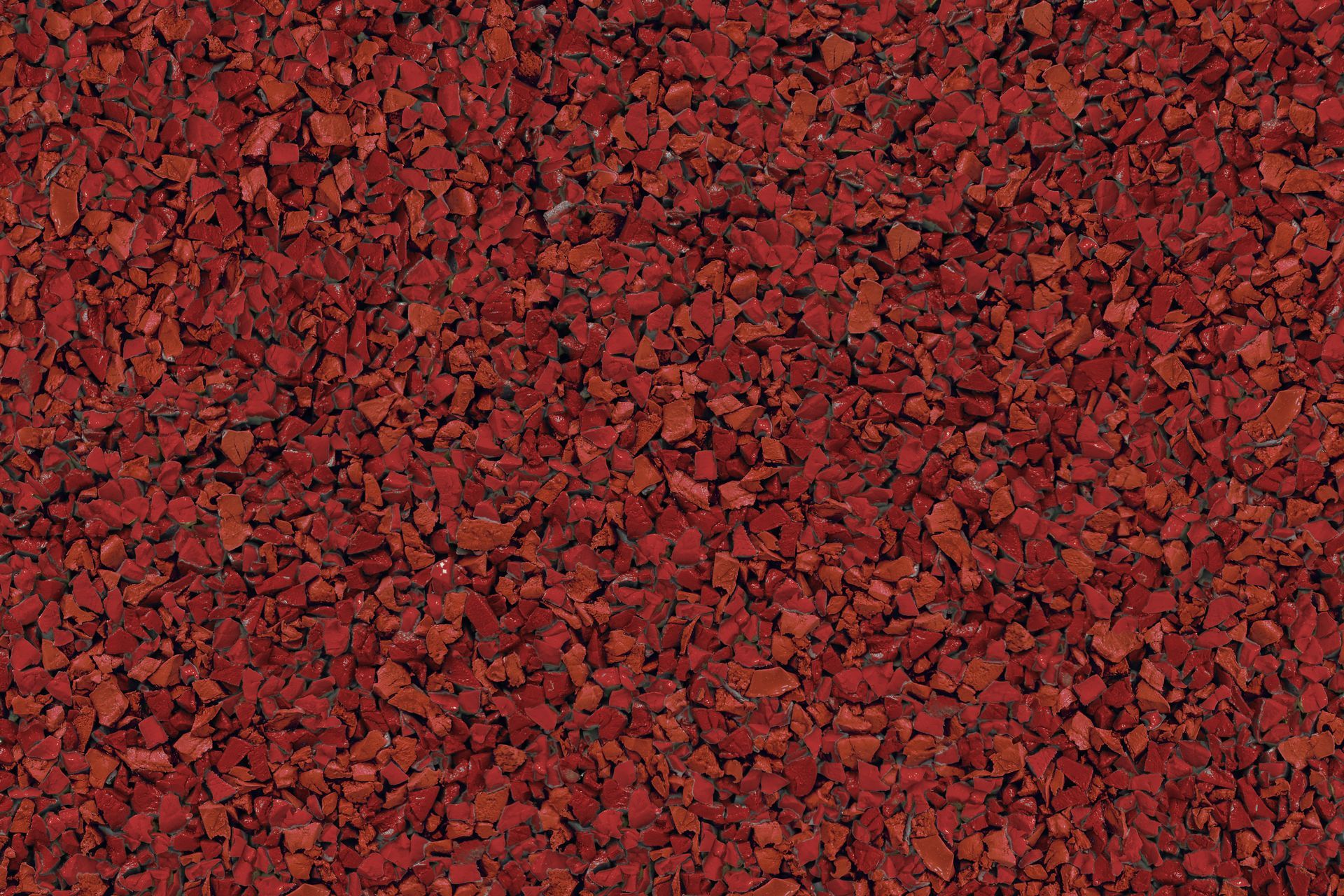 A close up of a pile of red gravel.