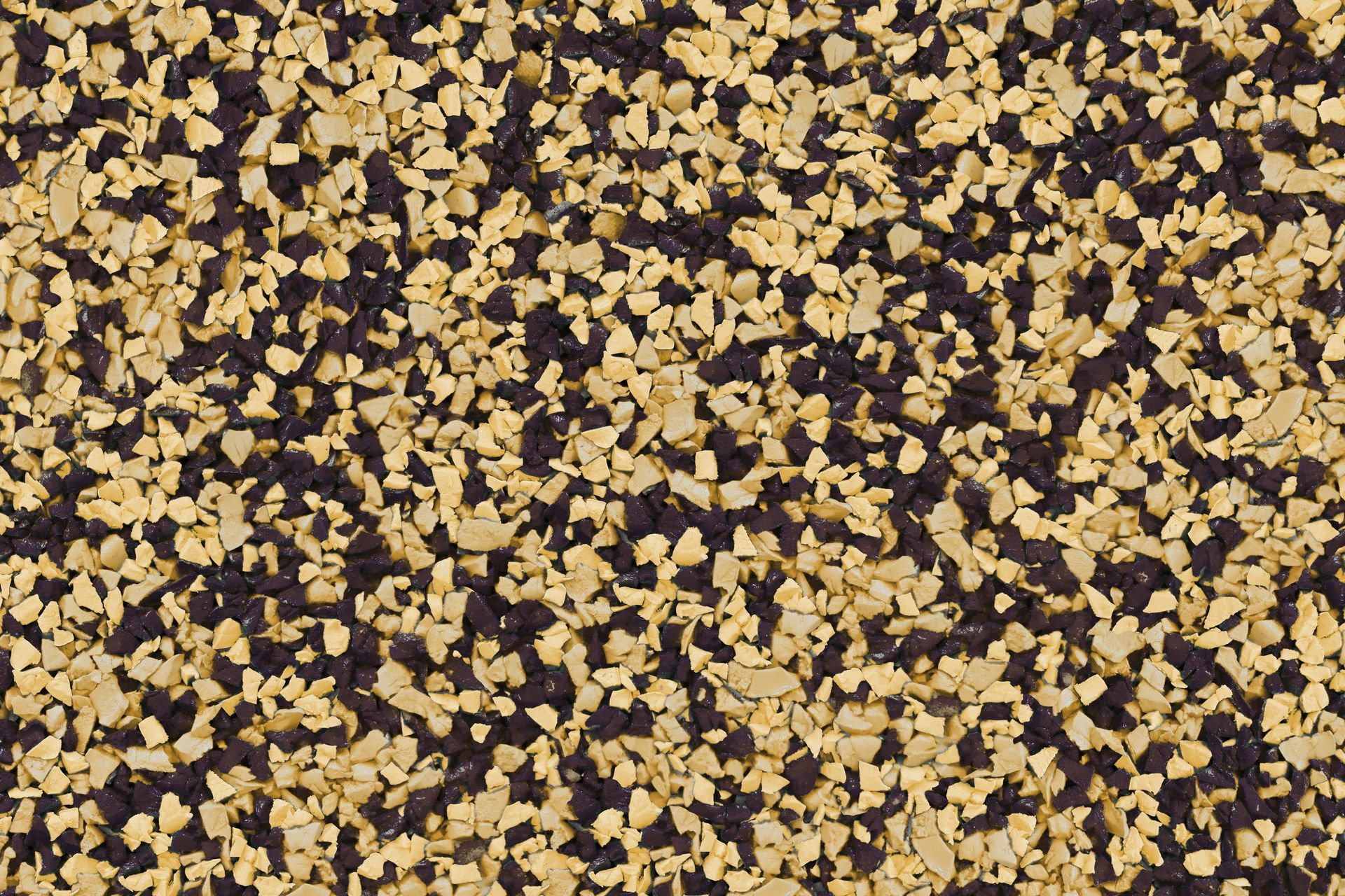 A close up of a pile of black and yellow gravel.