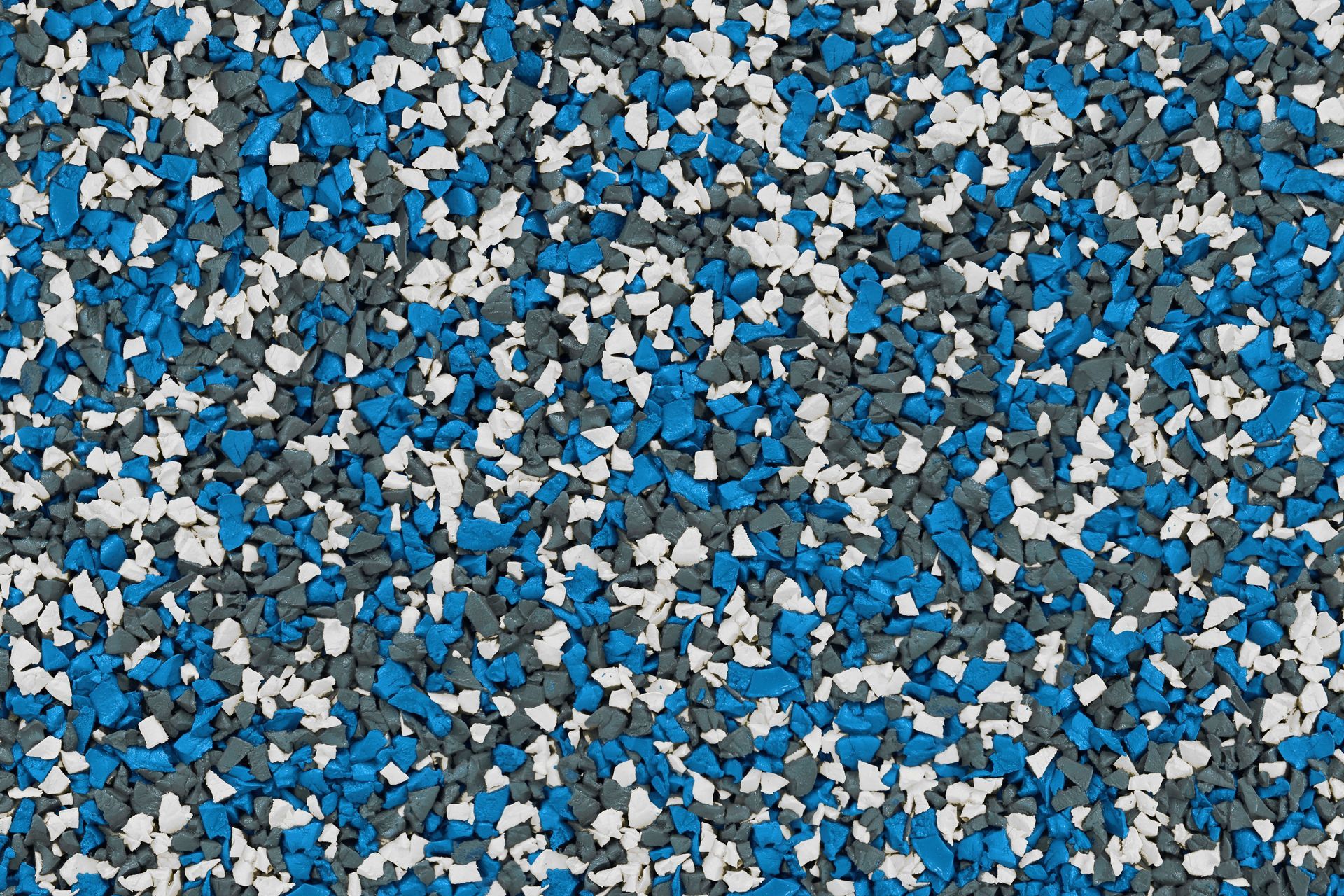 A close up of a blue , white and gray rubber floor.