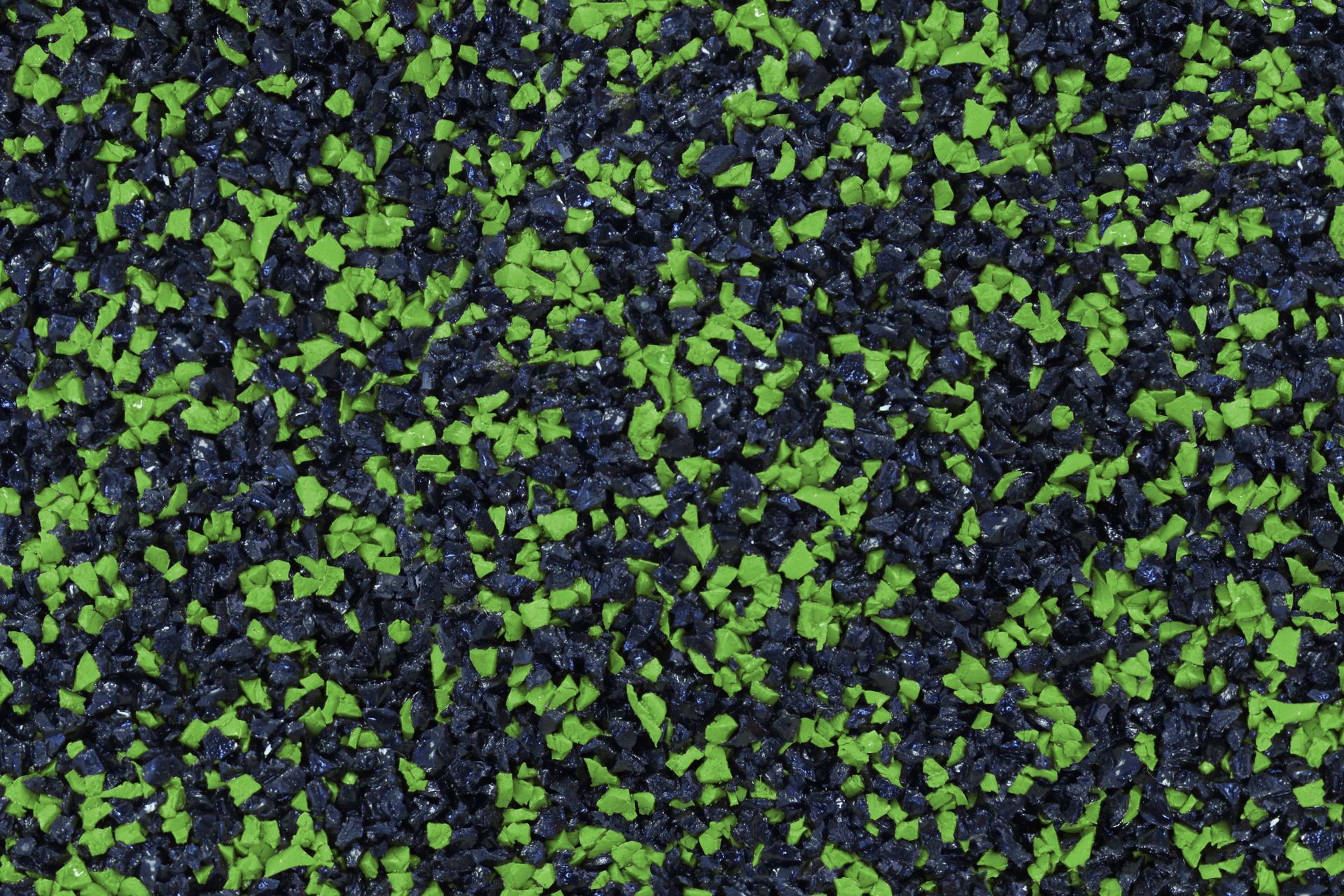 A close up of a green and black rubber surface.