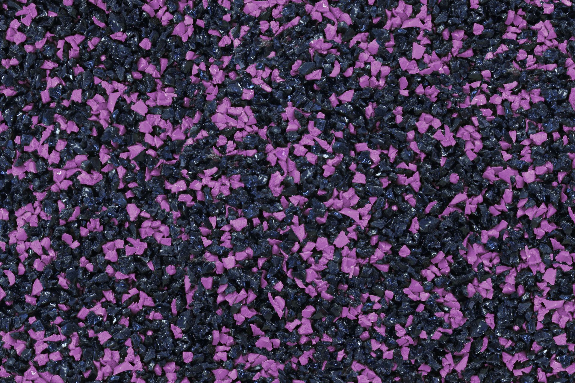 A close up of a pile of black and purple gravel.