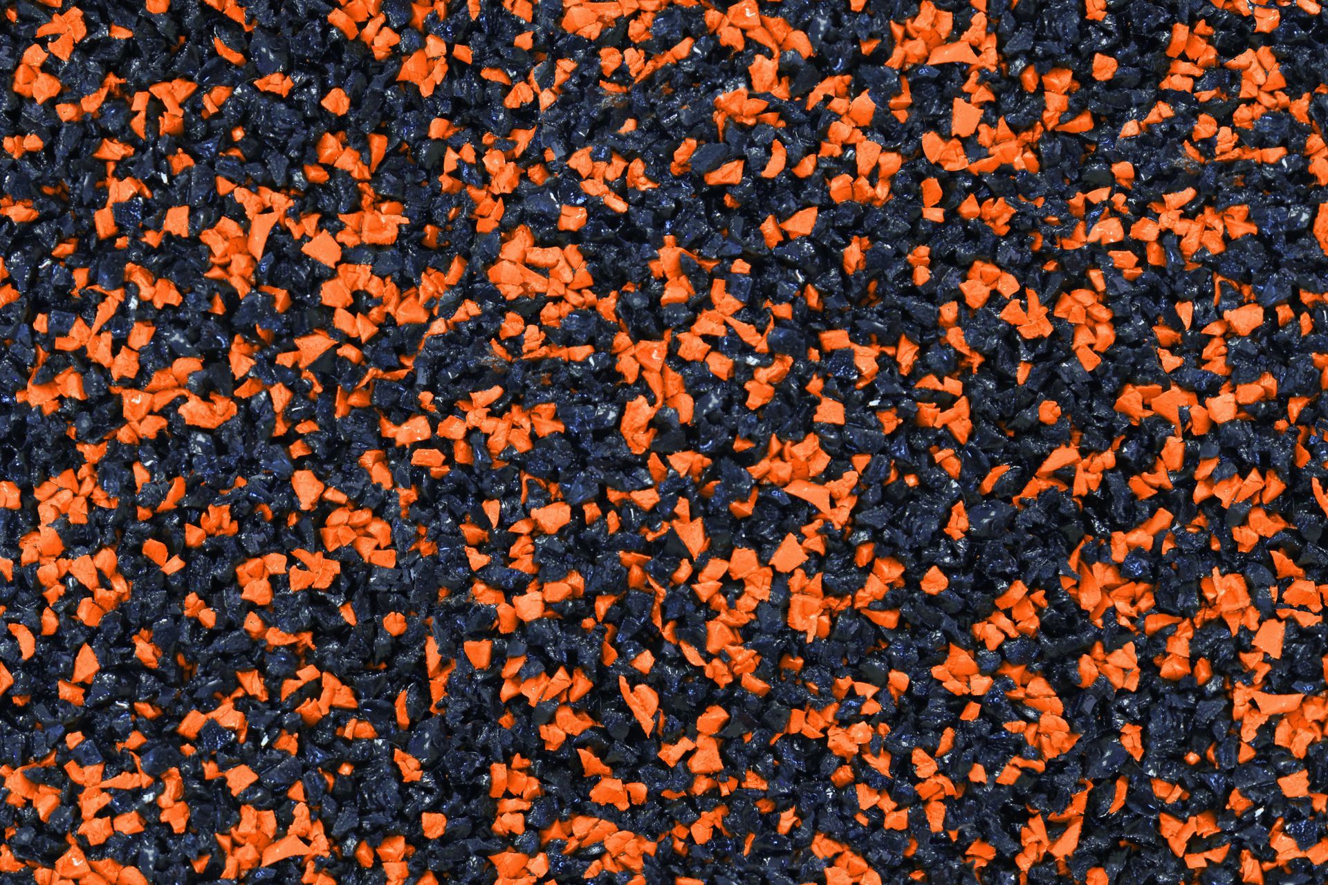 A close up of a black and orange rubber surface.