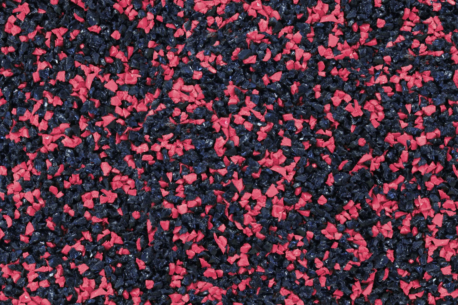 A close up of a pile of red and black gravel.