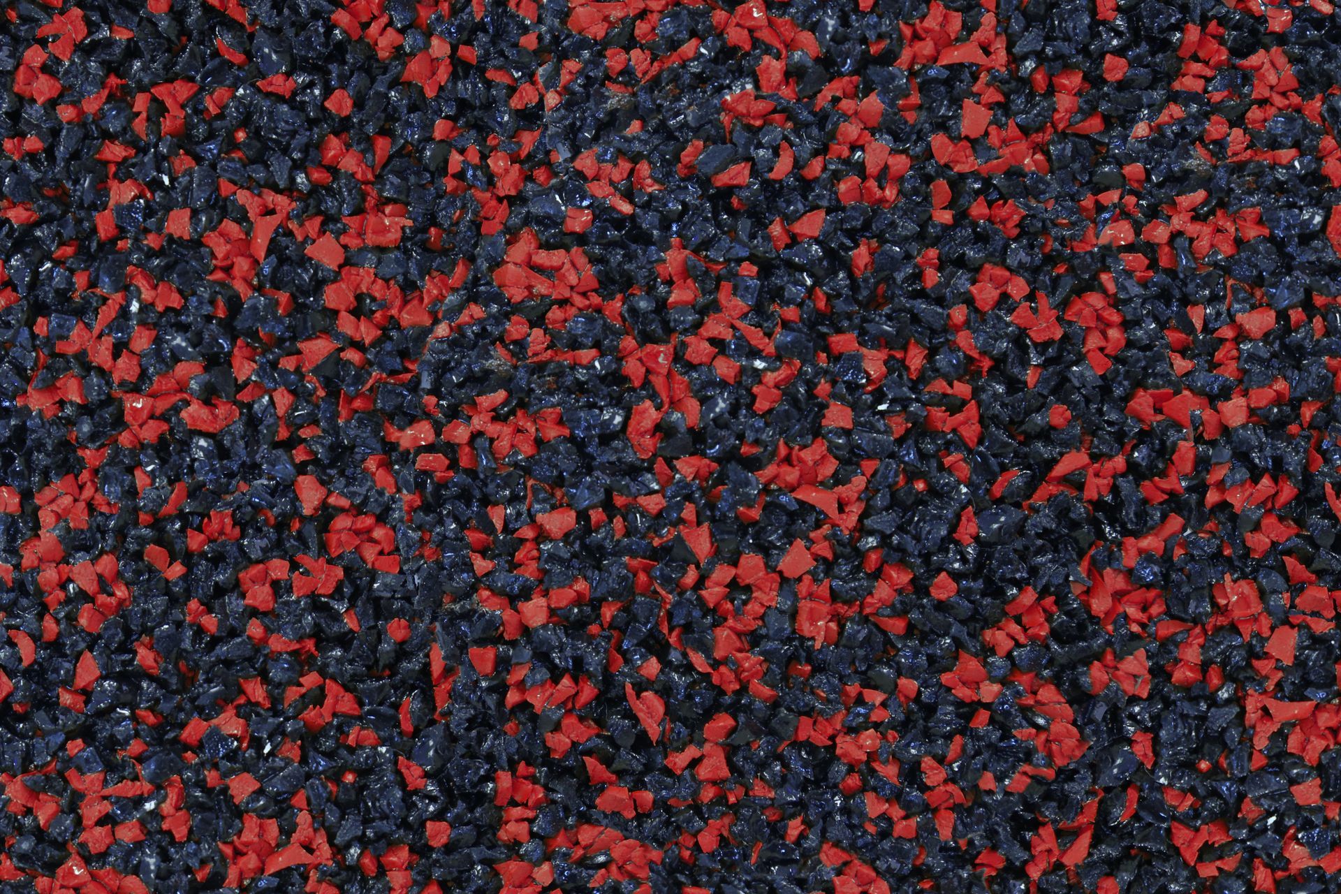 A close up of a pile of red and black gravel.