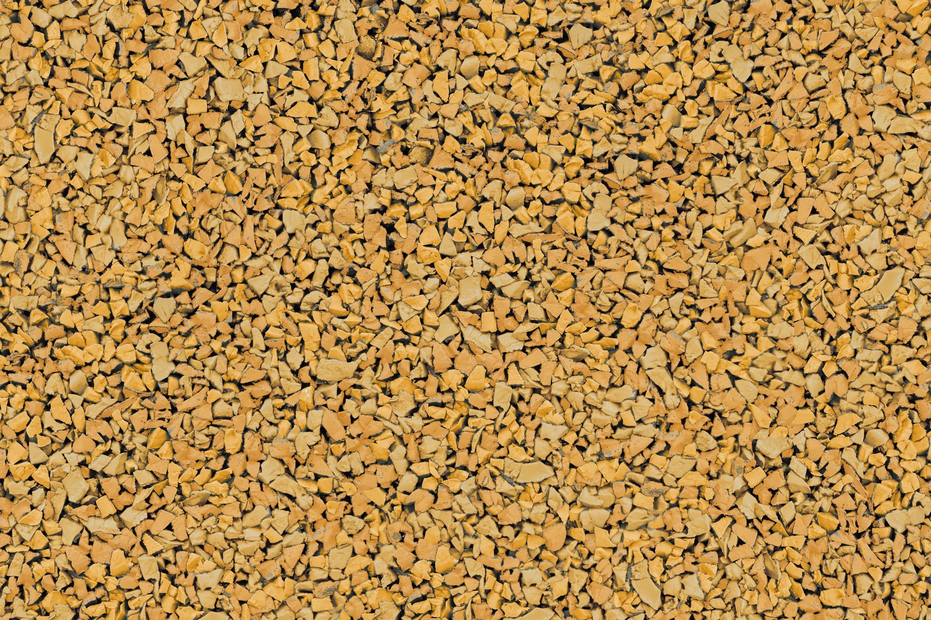 A close up of a pile of yellow gravel.