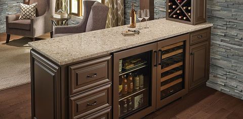 Built-in wooden bar cabinet with granite top, wine rack, glass storage, and mini fridge in a stylish living room
