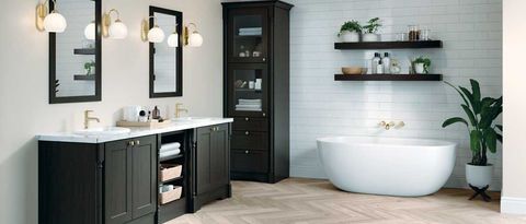 Modern bathroom with black vanity, round mirrors, freestanding tub, open shelves, and wood flooring