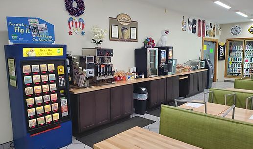 School cafeteria with vending machines, drink stations, and green seating booths