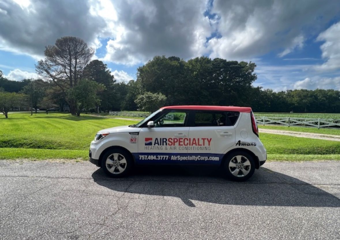 A white and red car is parked on the side of the road.