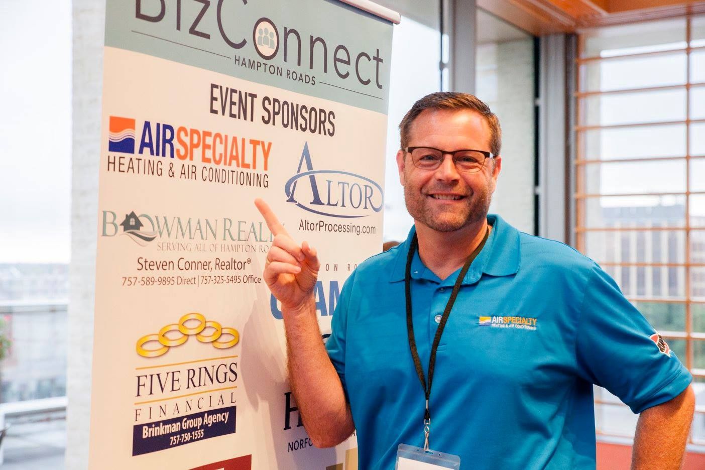 A man standing in front of a sign