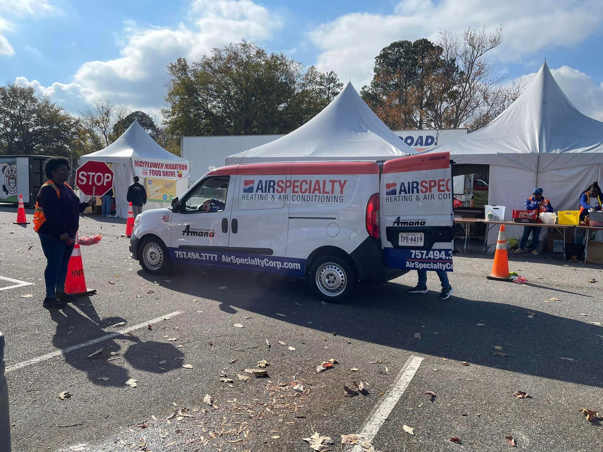 A white van that says air specialty is parked in a parking lot