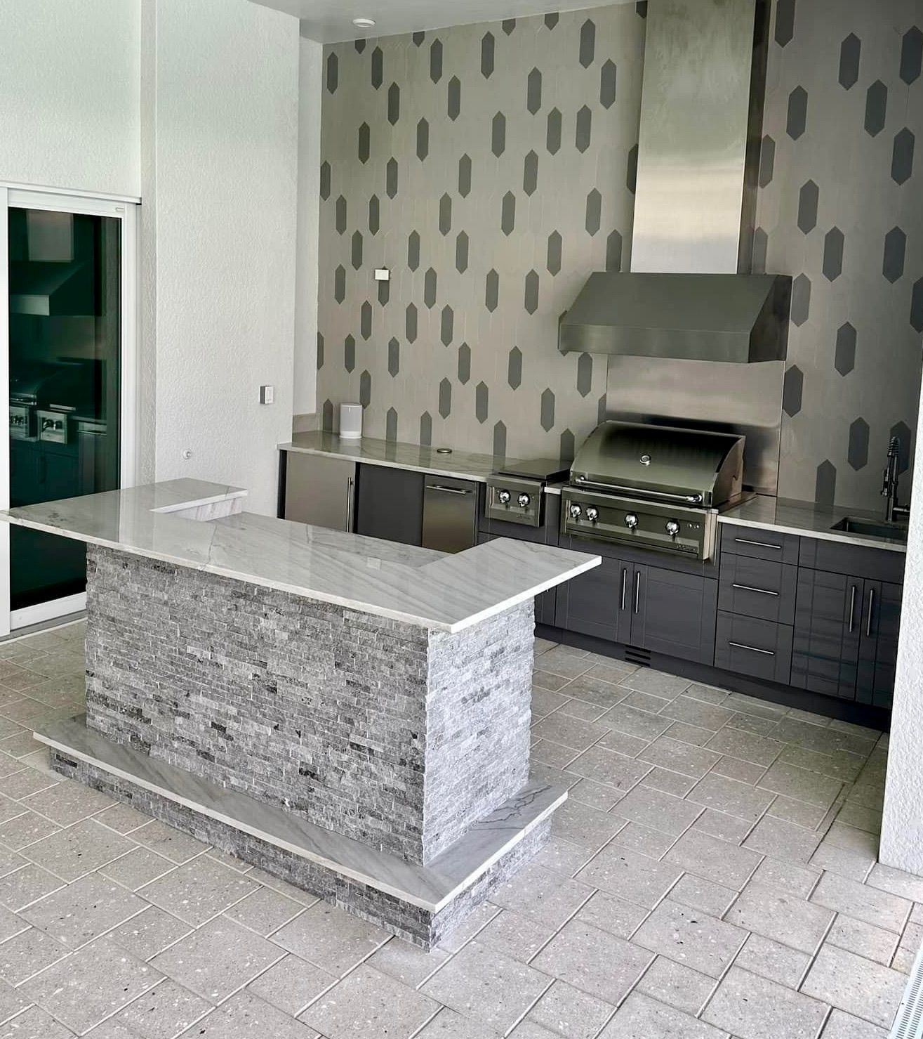 A kitchen with a large island and a grill.