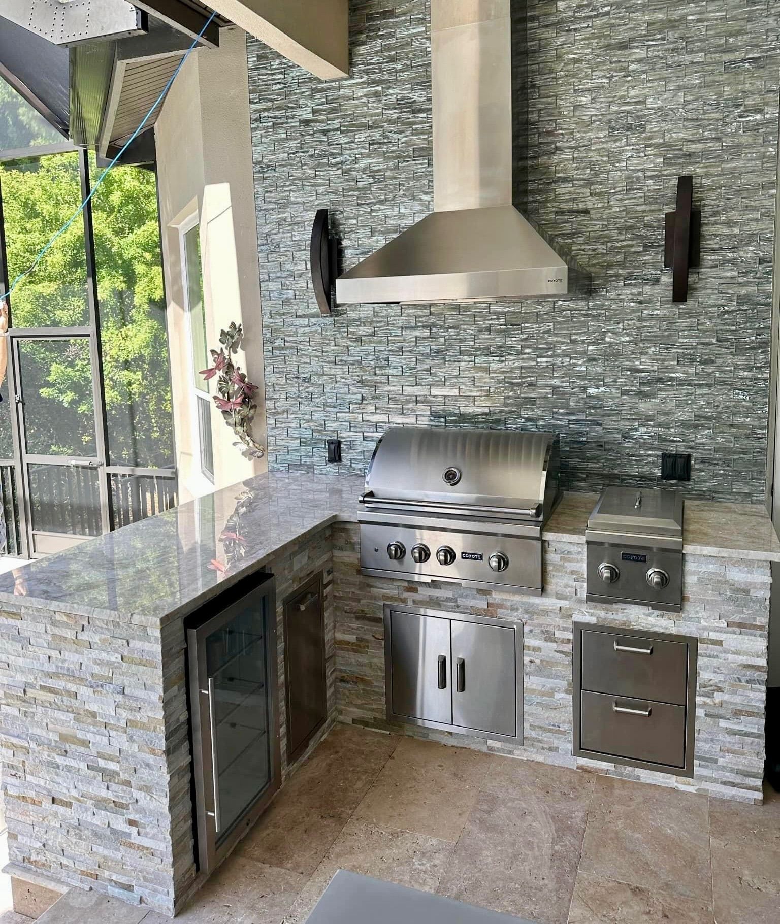 A kitchen with a grill and a hood above it.