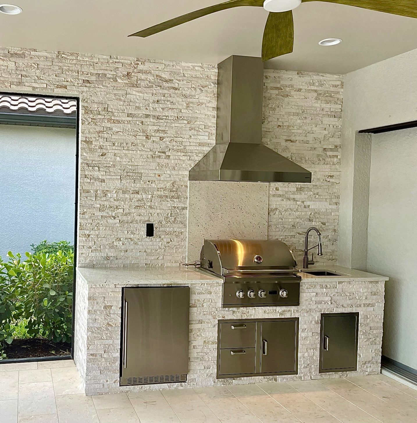 A kitchen with a grill and a ceiling fan.