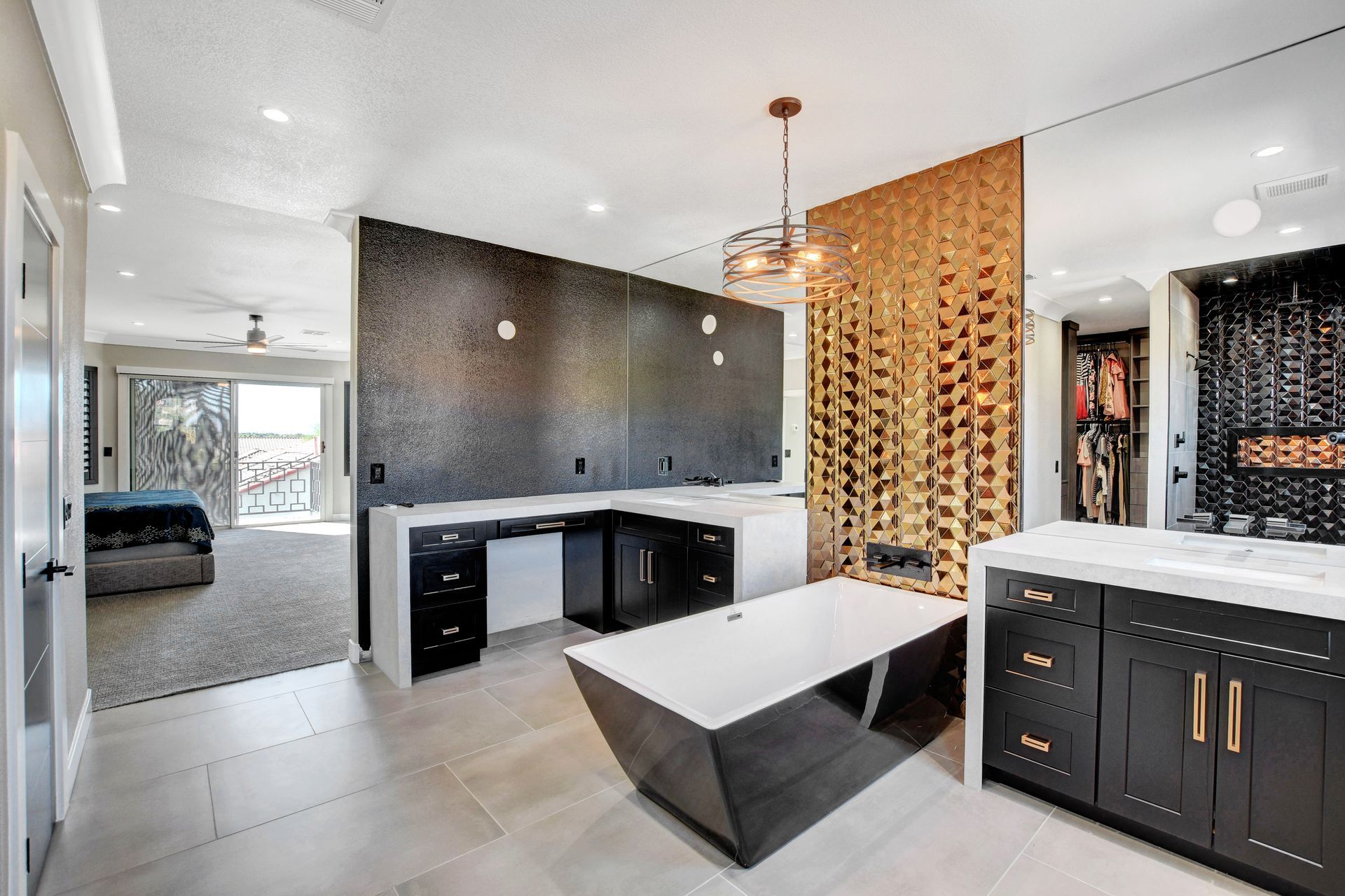 Luxurious bathroom with black and gold accents, large vanity, and walk-in closet.
