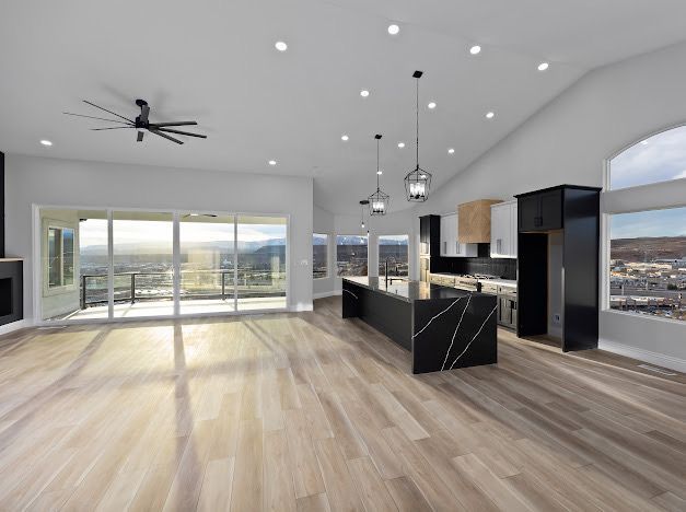 Spacious, modern kitchen and living area with mountain views and hardwood floors.