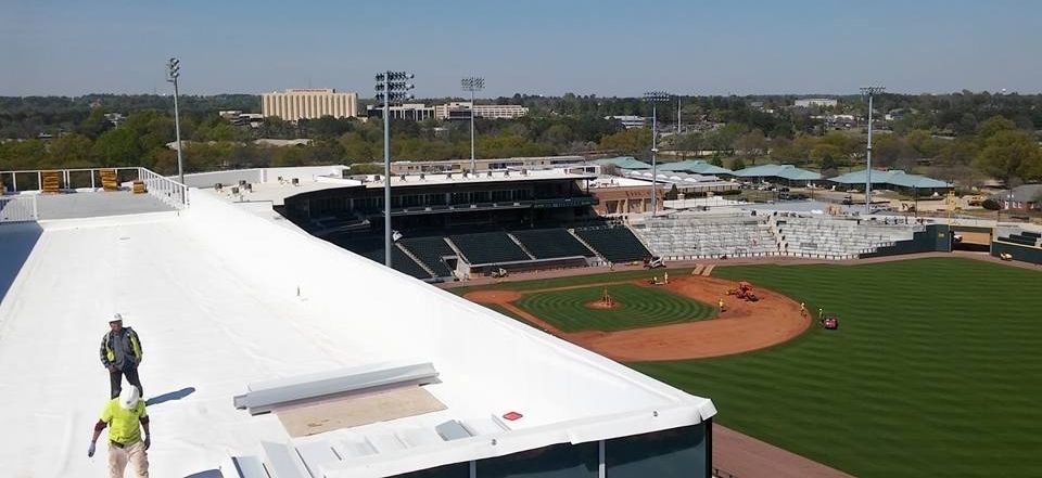 An aerial view of a baseball stadium with a white roof