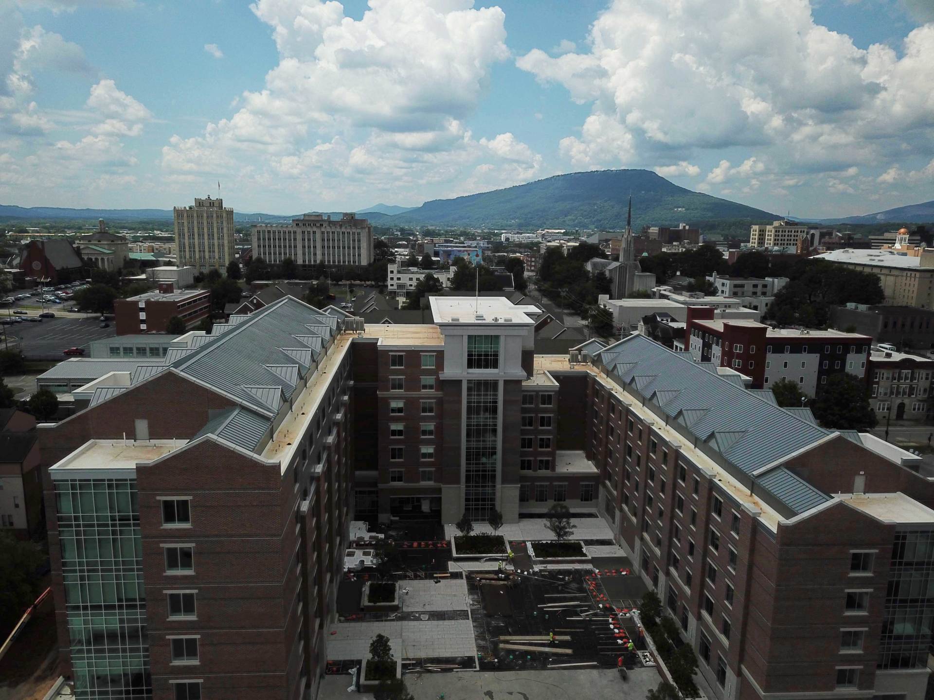 An aerial view of a city with mountains in the background