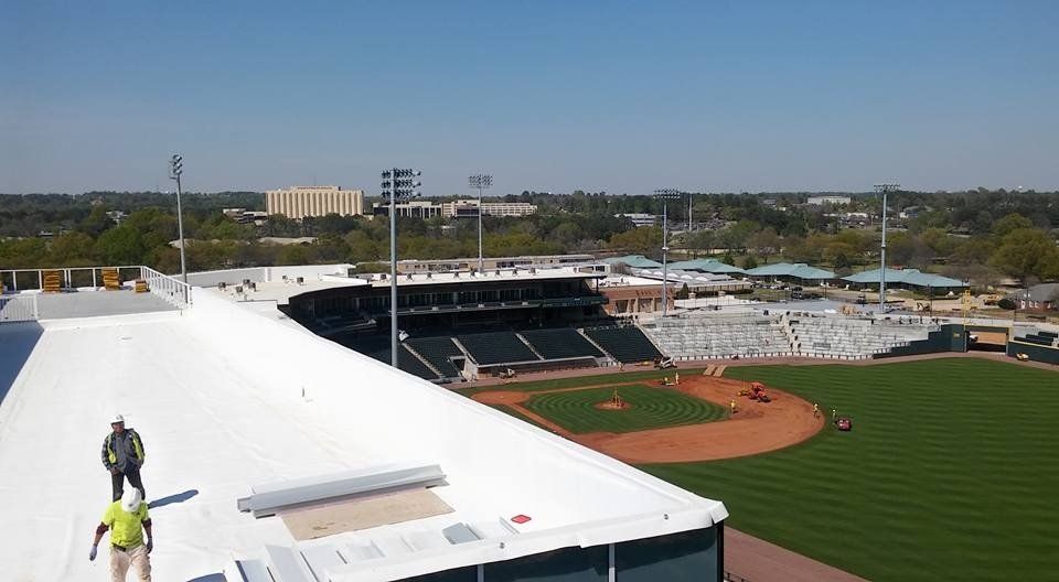 An aerial view of a baseball stadium with a white roof