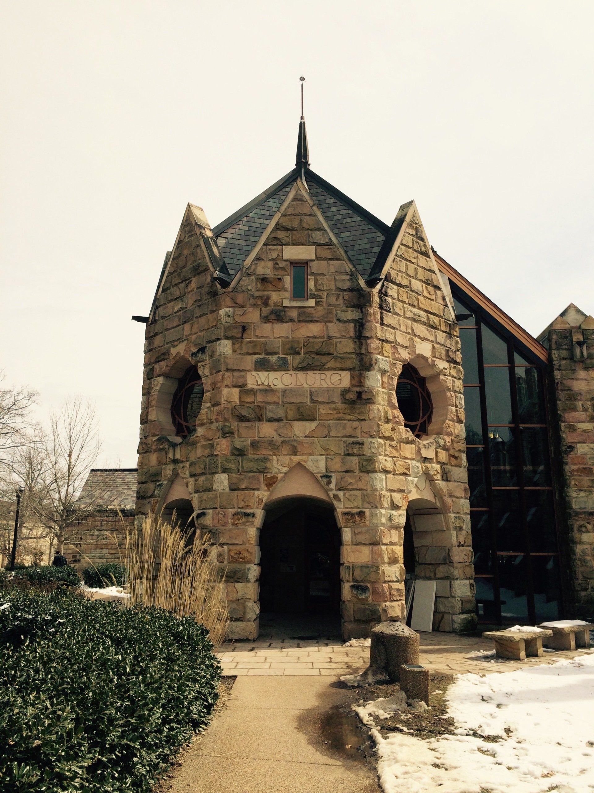 A small stone building with a steeple on top of it