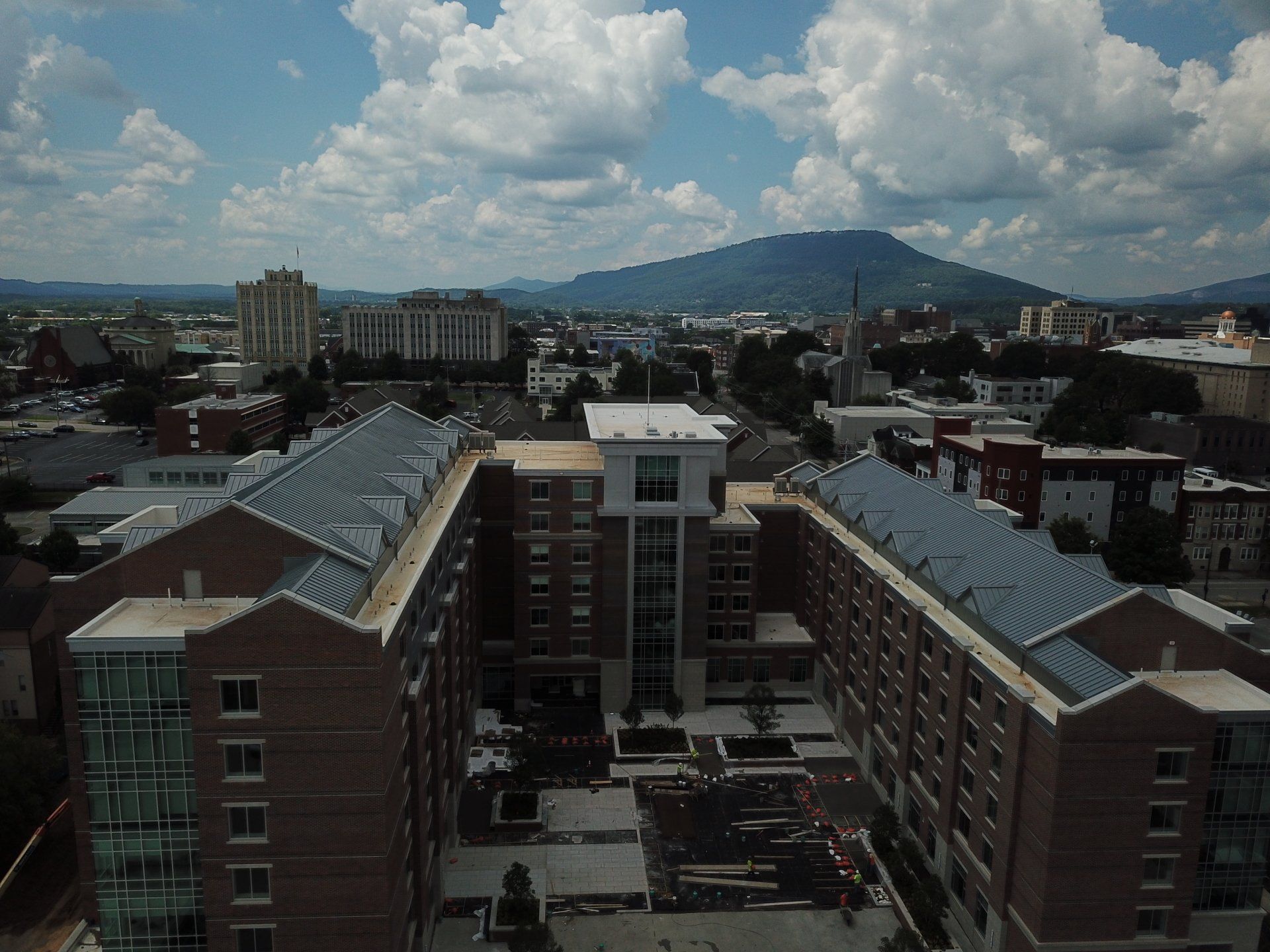 An aerial view of a city with mountains in the background