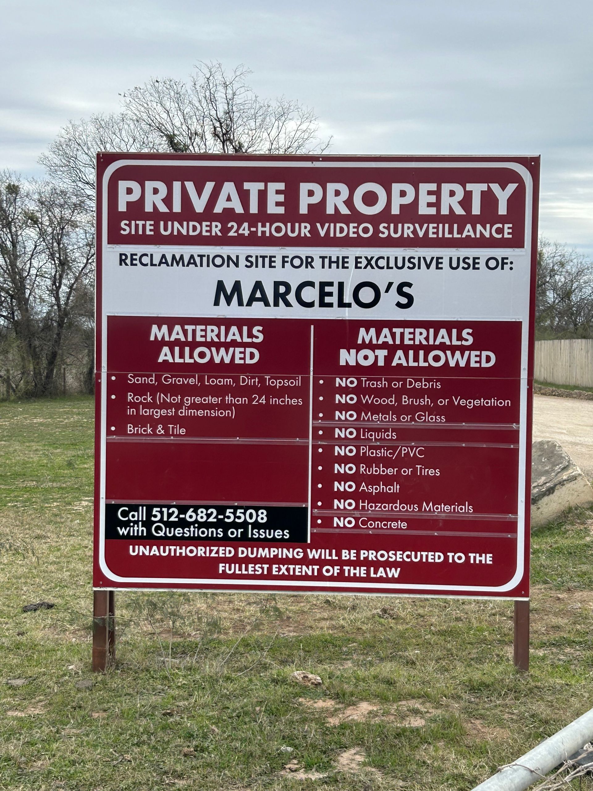A red sign that says private property site under 24-hour video surveillance