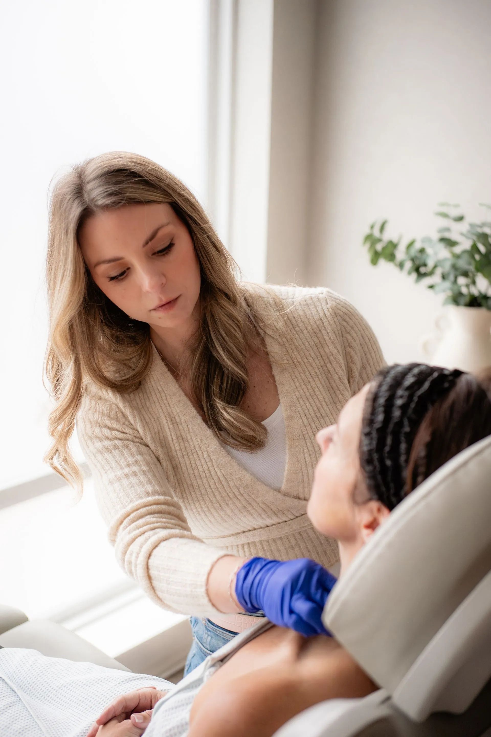 Caregiver comforting a patient in a bright clinic room