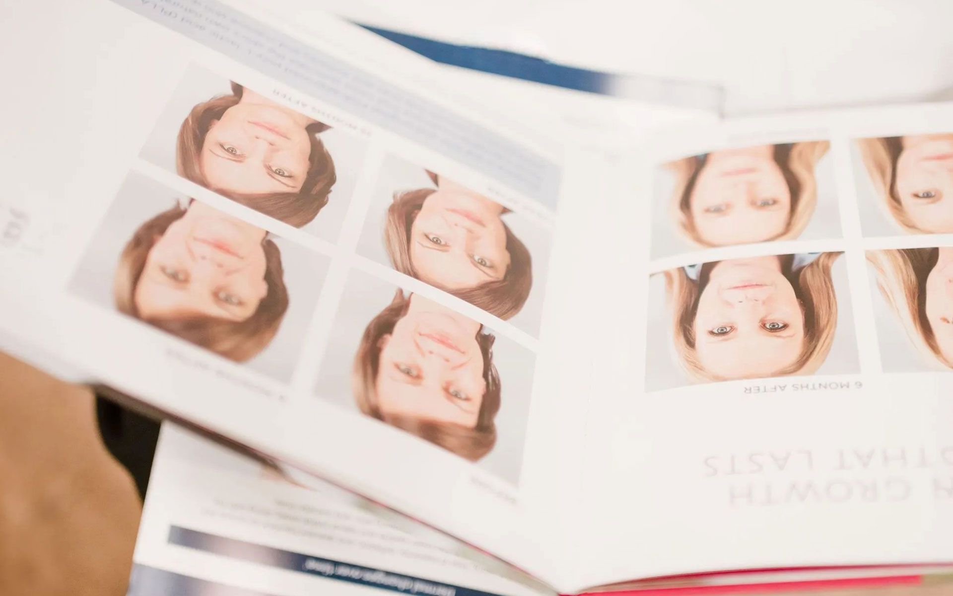Open magazine with close-up portrait photos on white pages, shown at an angle on a table